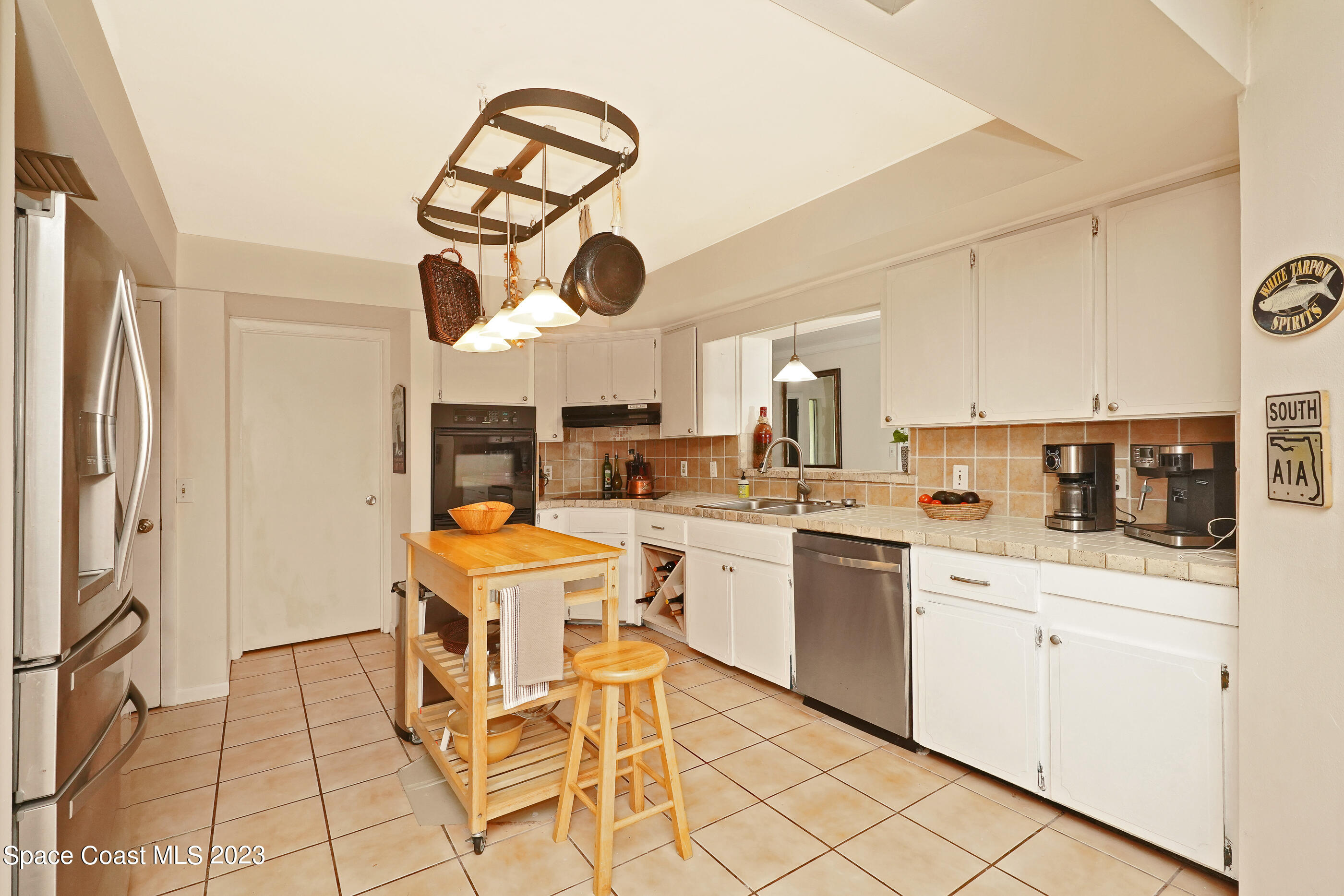 2525 Friday Road Cocoa, FL 32926 - Photo 13 of 77 a kitchen with stainless steel appliances kitchen island granite countertop a sink and cabinets