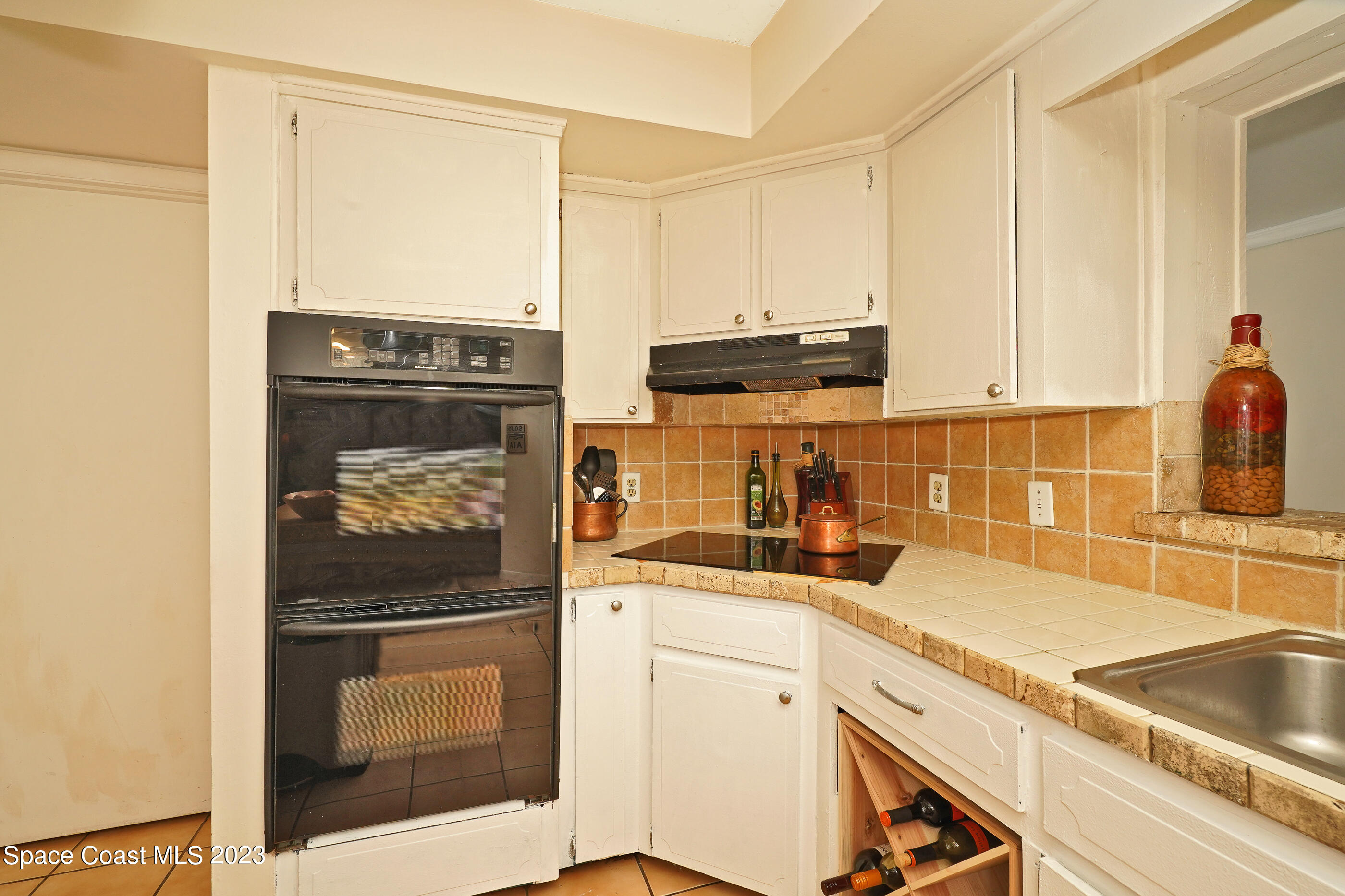 2525 Friday Road Cocoa, FL 32926 - Photo 14 of 77 a kitchen with stainless steel appliances granite countertop a sink stove and microwave