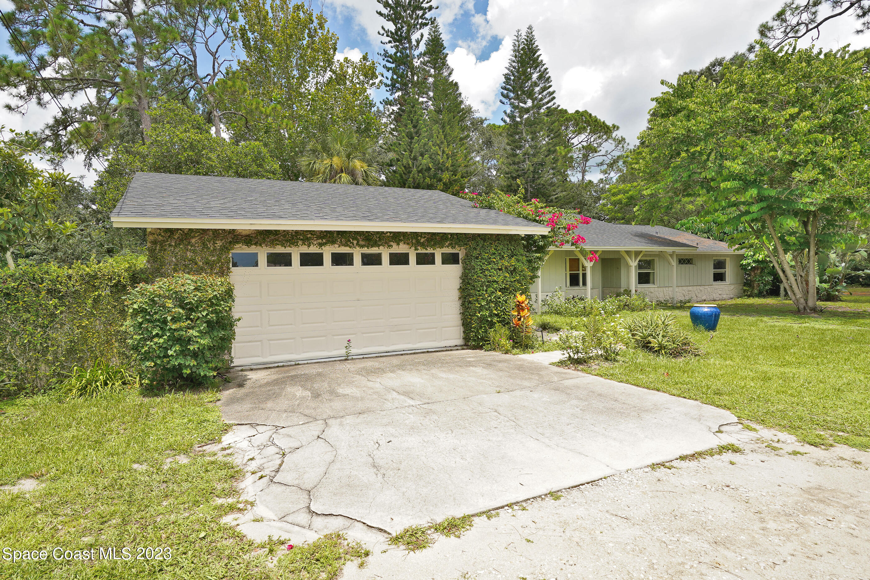 2525 Friday Road Cocoa, FL 32926 - Photo 2 of 77 a front view of a house with a yard and garage