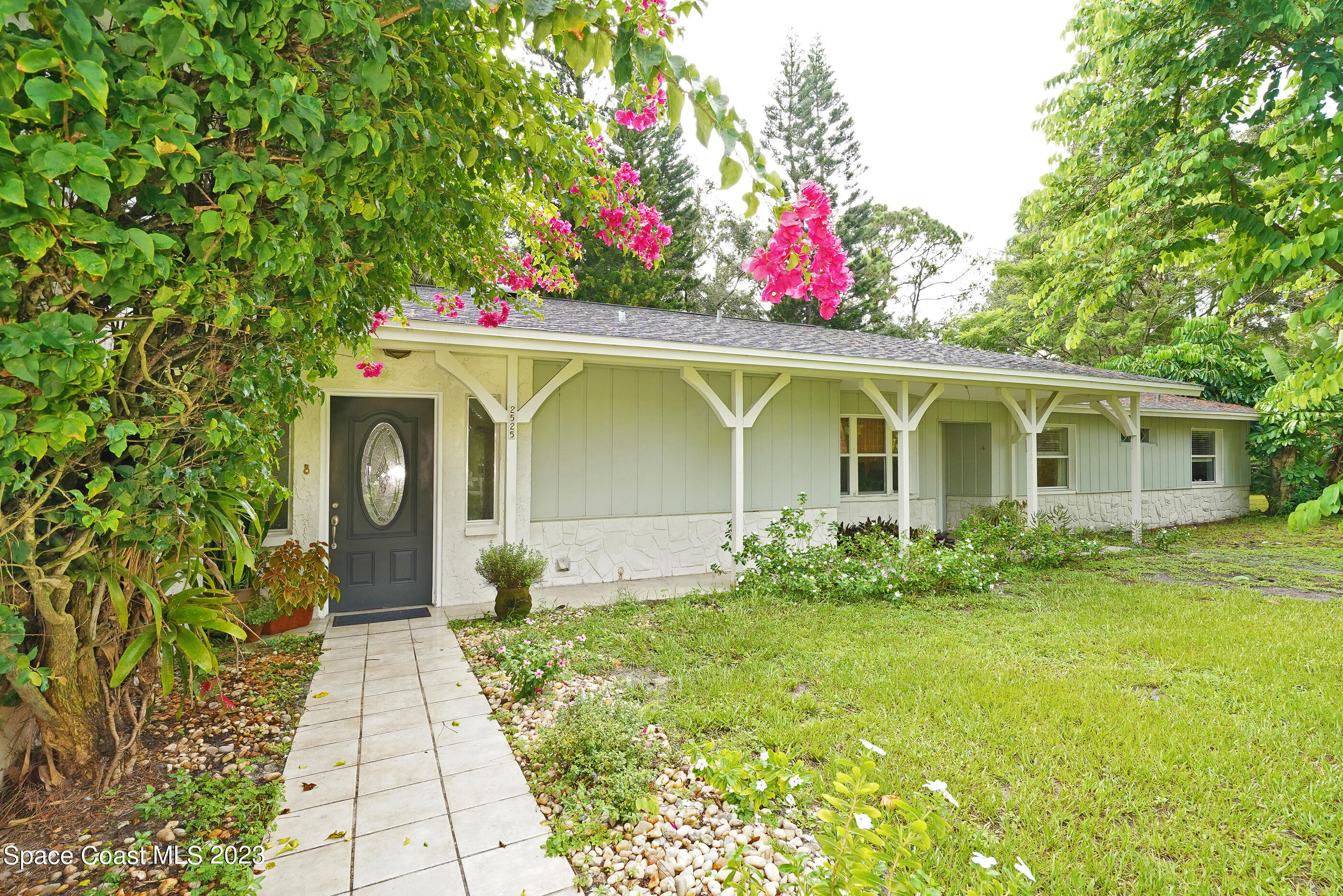 2525 Friday Road Cocoa, FL 32926 - Photo 3 of 77 a front view of a house with a yard