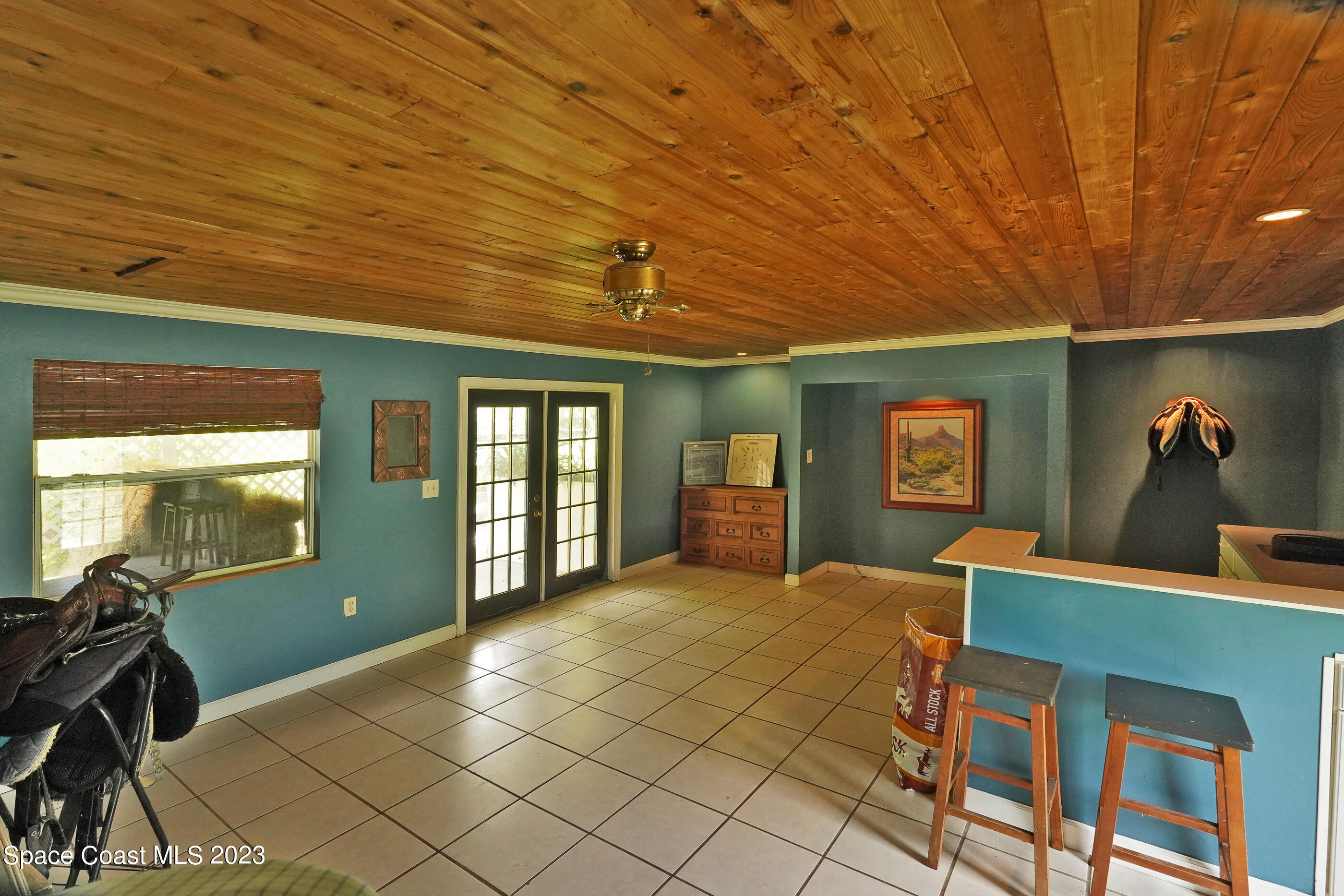 2525 Friday Road Cocoa, FL 32926 - Photo 39 of 77 a bedroom with a bed and a dresser next to a window