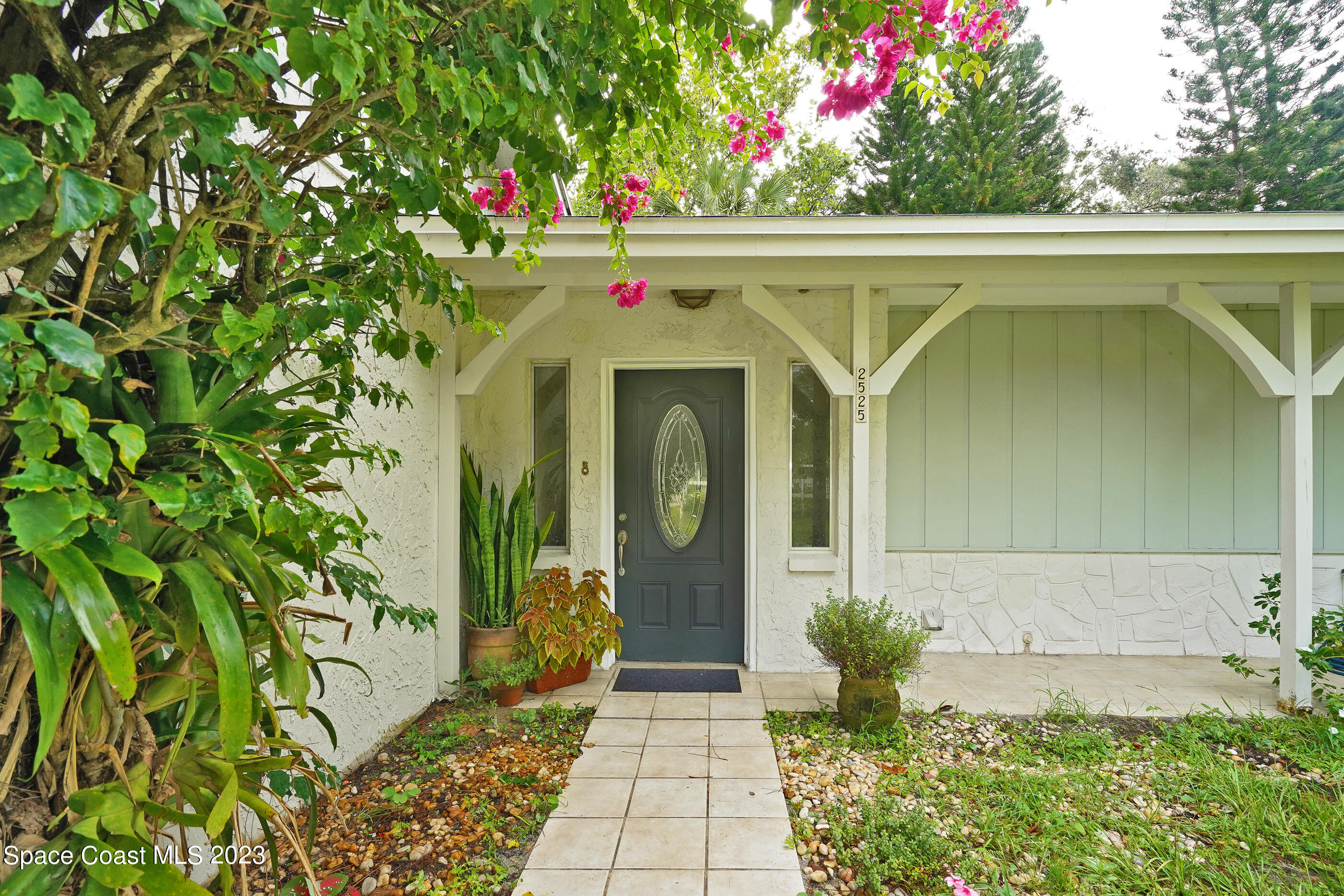 2525 Friday Road Cocoa, FL 32926 - Photo 4 of 77 a front view of a house with lots of yellow lighting