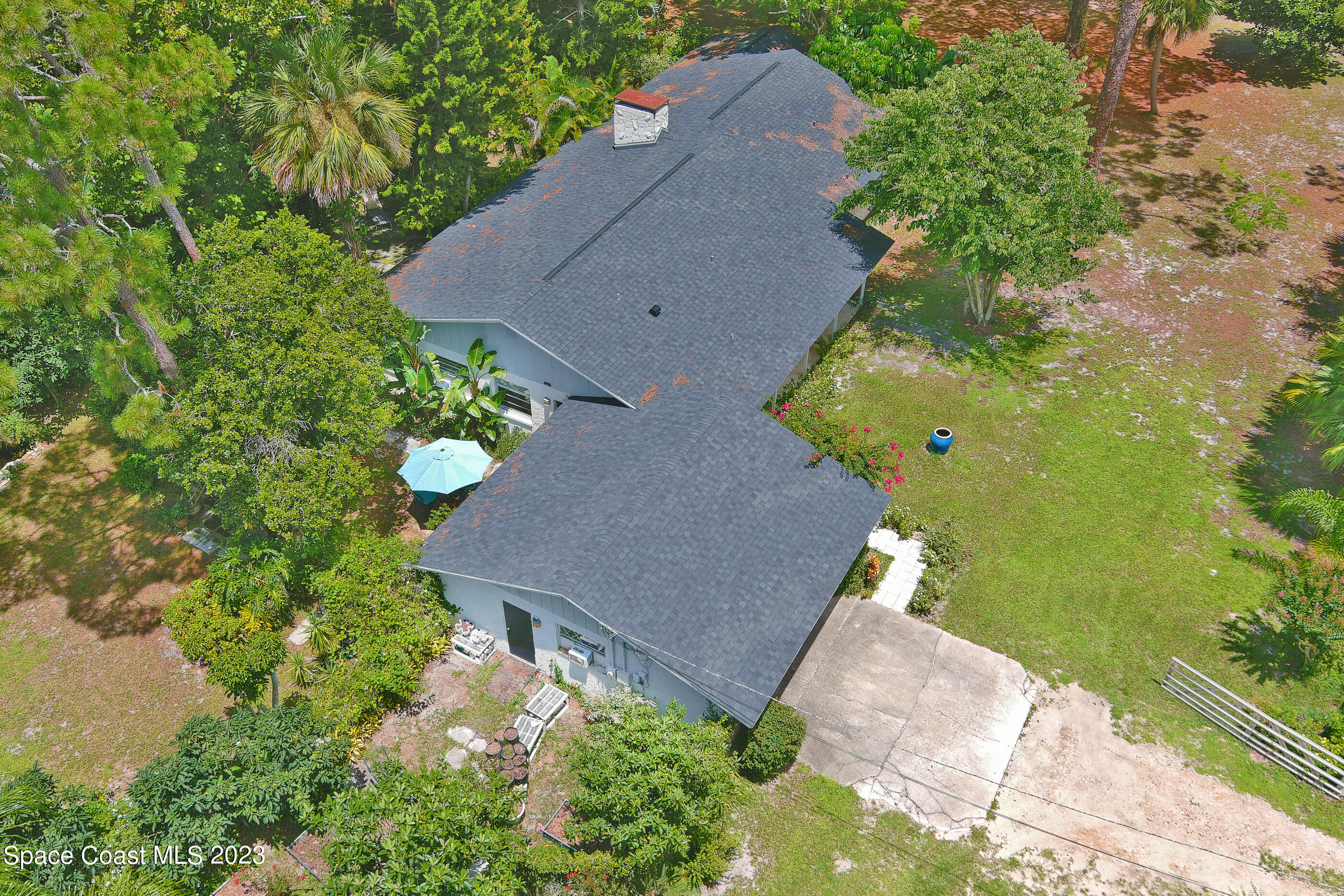 2525 Friday Road Cocoa, FL 32926 - Photo 54 of 77 an aerial view of a house with a yard and a large tree