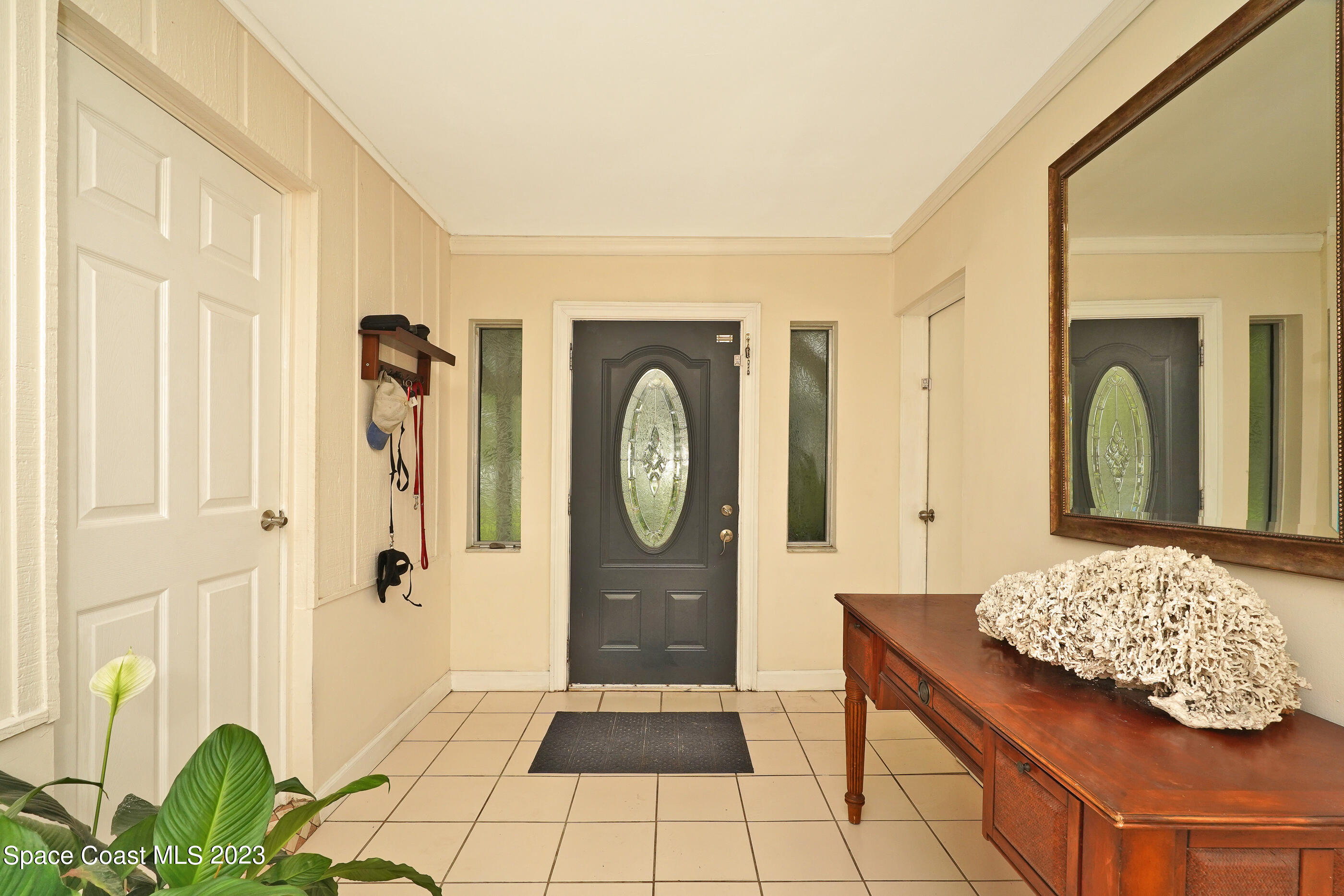 2525 Friday Road Cocoa, FL 32926 - Photo 6 of 77 a bedroom with a bed a potted plant and a dresser