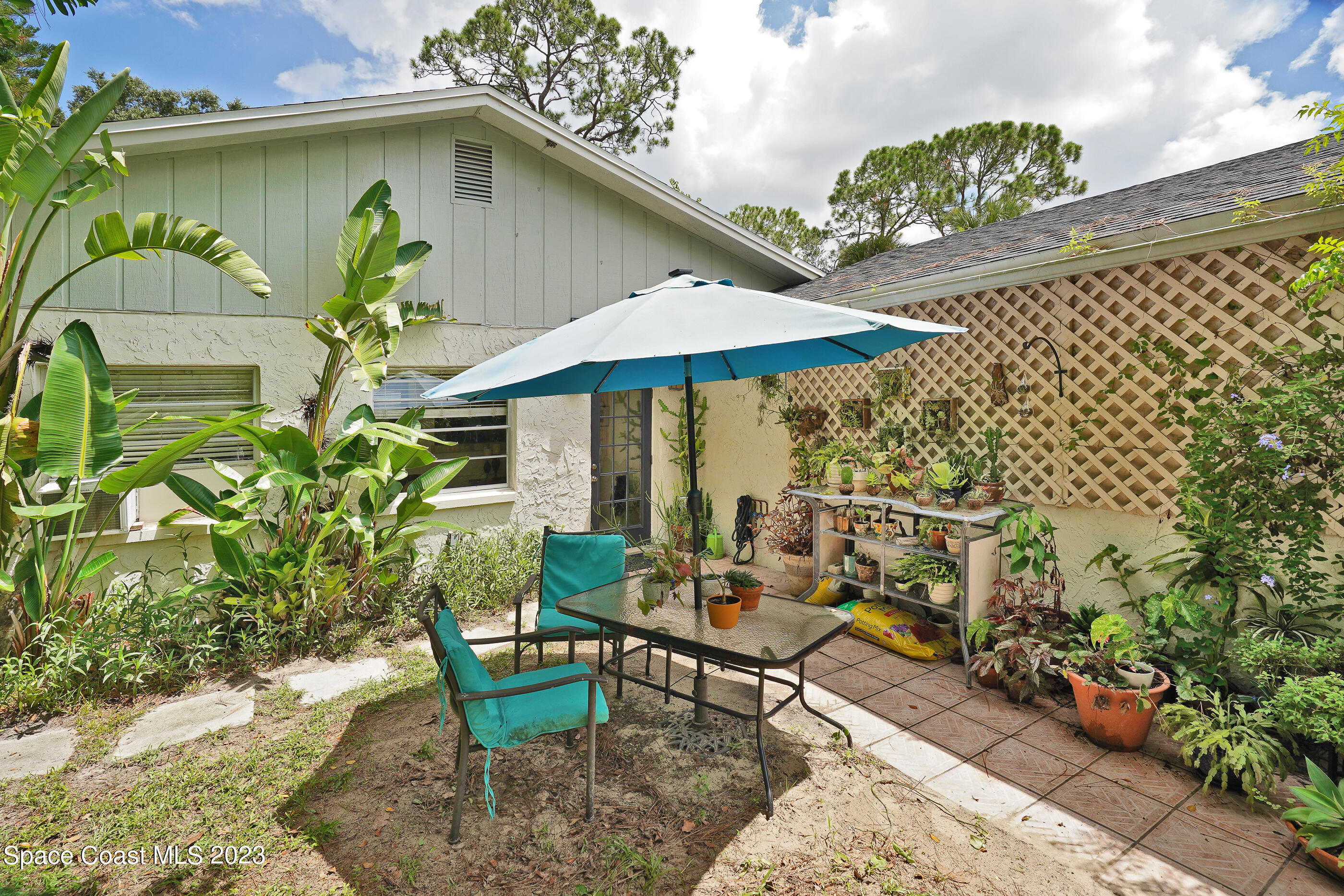 2525 Friday Road Cocoa, FL 32926 - Photo 77 of 77 a view of a chairs and table under an umbrella