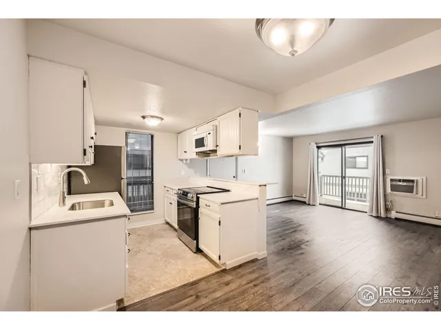 a kitchen with a stove a sink dishwasher and a refrigerator