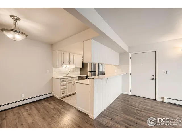 a kitchen with a sink cabinets and wooden floor
