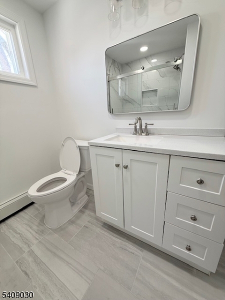 114 North Beverwyck Road, Unit 11 Lake Hiawatha, NJ 07034 - Photo 12 of 17 a bathroom with a toilet a sink and mirror