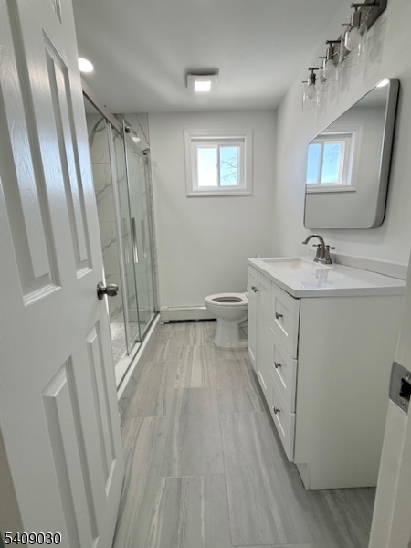114 North Beverwyck Road, Unit 11 Lake Hiawatha, NJ 07034 - Photo 9 of 17 a spacious bathroom with a double vanity sink a toilet a mirror and shower
