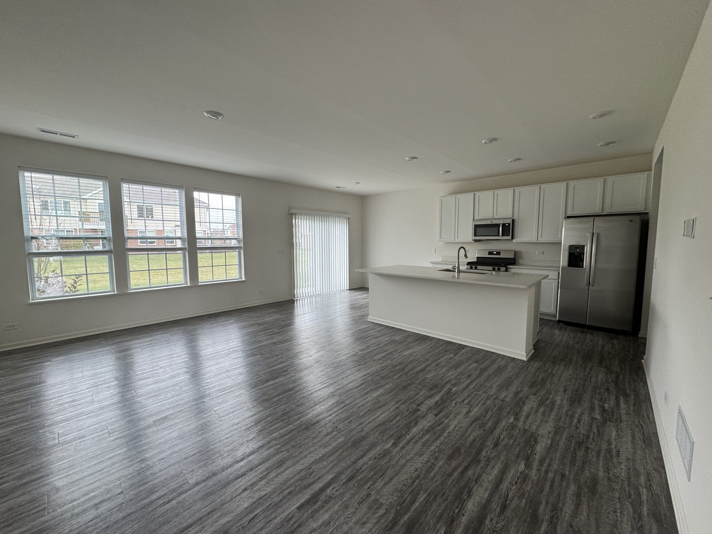 1226 Draper Road McHenry, IL 60050 - Photo 2 of 17 a view of a kitchen with wooden floor electronic appliances and windows