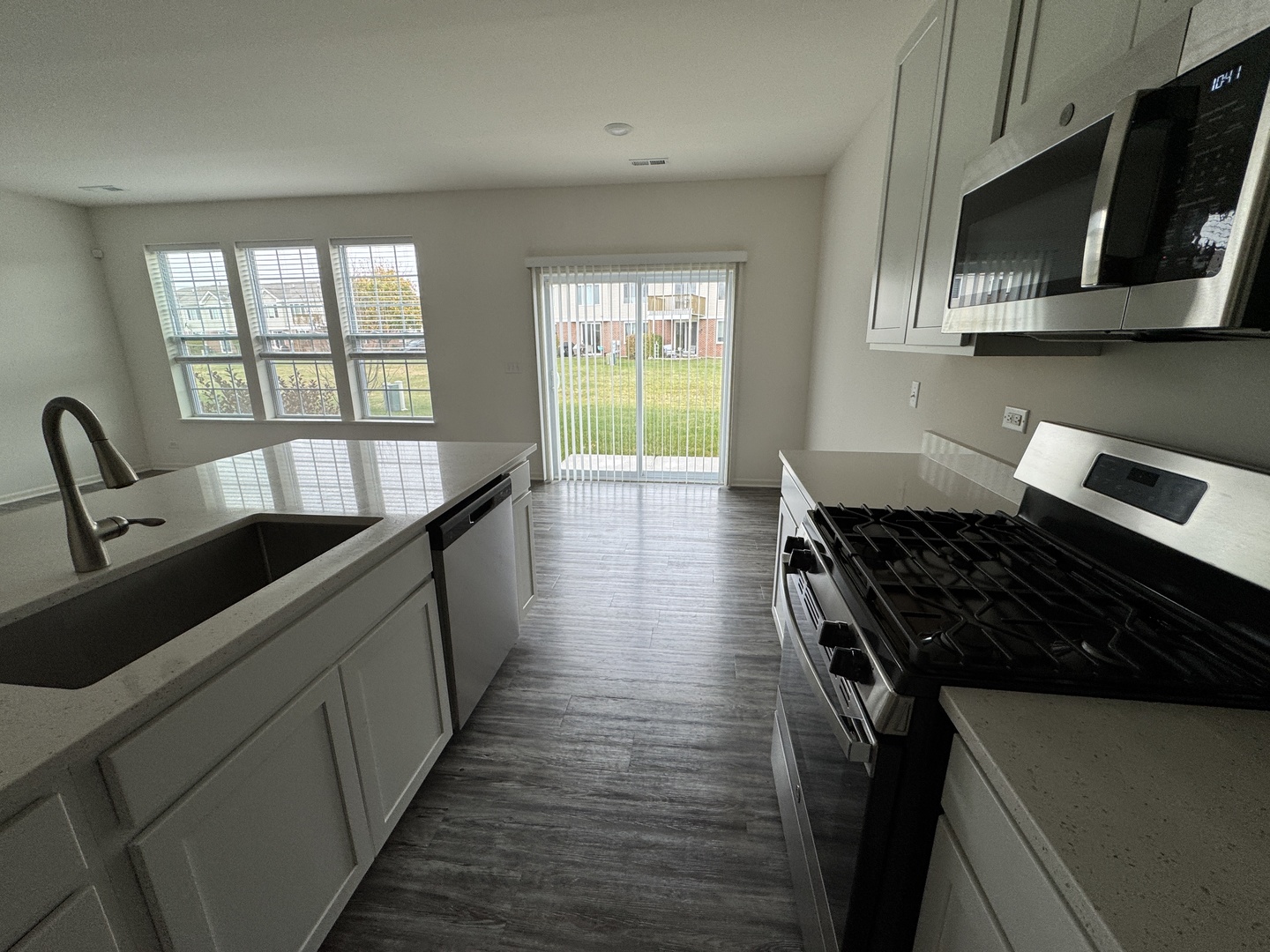 1226 Draper Road McHenry, IL 60050 - Photo 6 of 17 a kitchen with a stove a sink and a microwave