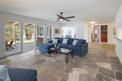 a view of a backyard with table and chairs and floor to ceiling window with wooden fence