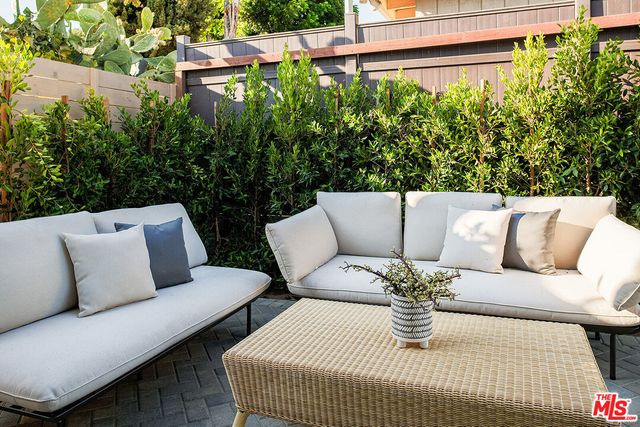 a balcony with outdoor seating and plants