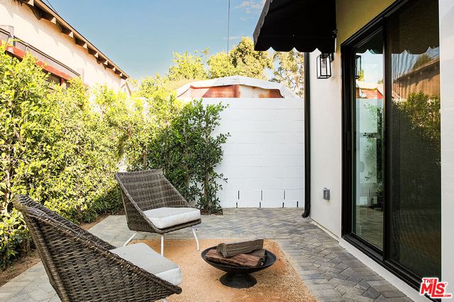 a backyard of a house with table and chairs