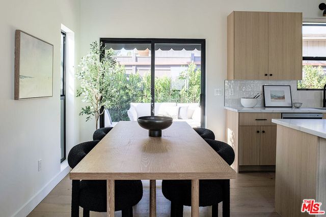 a view of a dining room with a table and chairs
