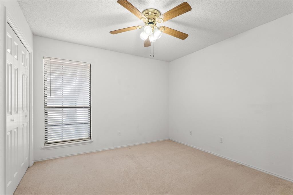 162 Warren Road Lorena, TX 76655 - Photo 25 of 39 Neutral wall finishes, carpeted flooring, window with blinds, and ceiling fan with integrated lighting