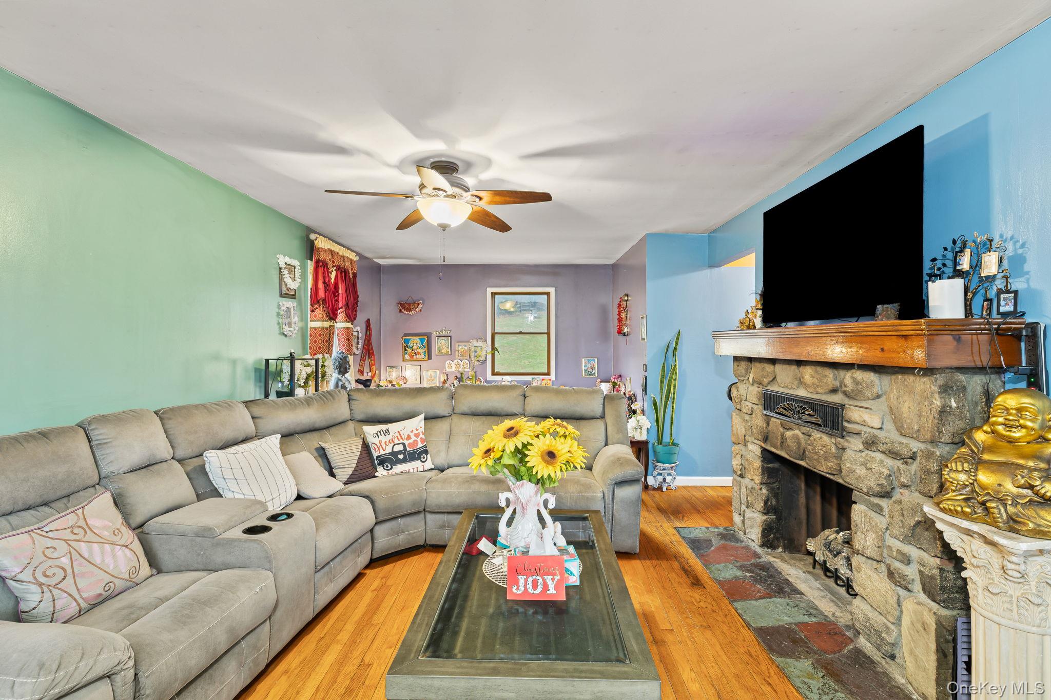 11 Cross Creek Road Cold Spring, NY 10516 - Photo 17 of 43 a living room with furniture a flat screen tv and a fireplace