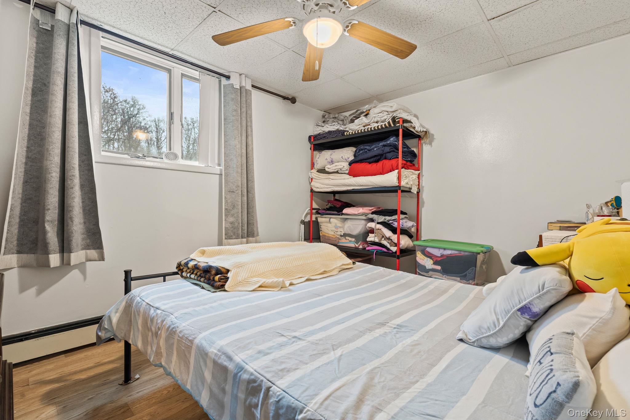 11 Cross Creek Road Cold Spring, NY 10516 - Photo 39 of 43 a bedroom with a bed and a chandelier