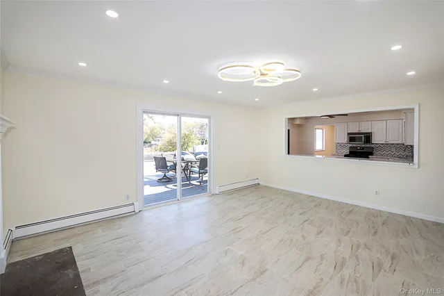 an empty room with wooden floor and a flat screen tv