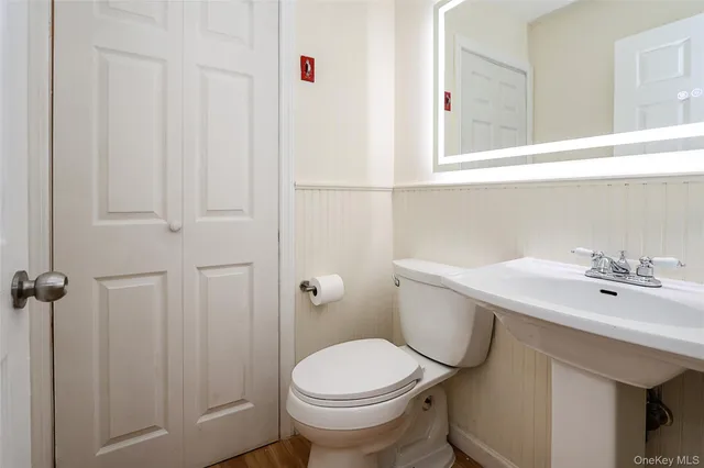 a white toilet sitting next to a bathroom sink