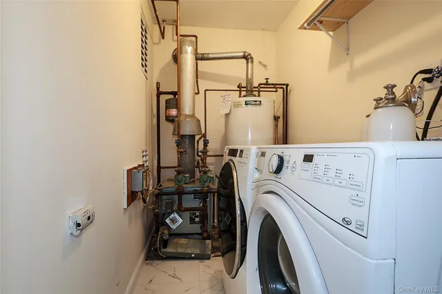 a view of storage and utility room with washer and dryer