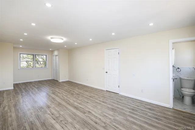 a view of an empty room and a window