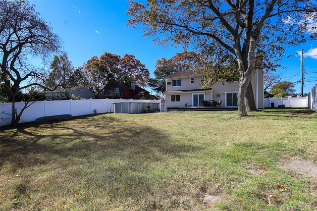 a view of a house with a yard and tree