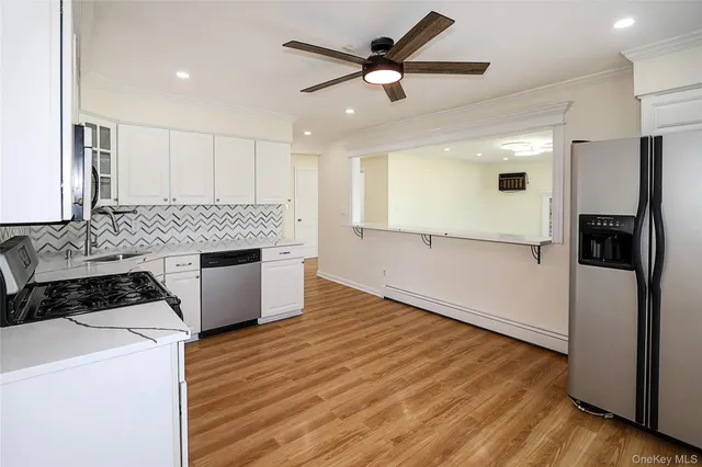 a kitchen with granite countertop a refrigerator and a stove top oven