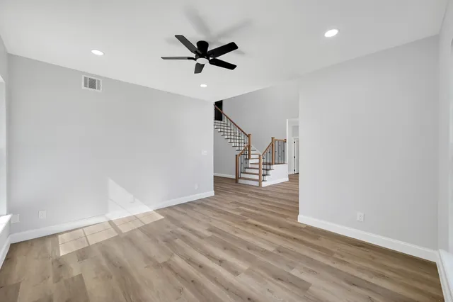 a kitchen with stainless steel appliances granite countertop a sink stove and wooden floor