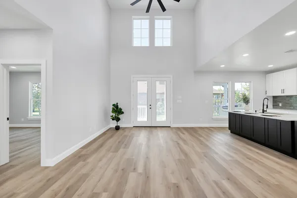 a view of a kitchen with wooden floor and a window