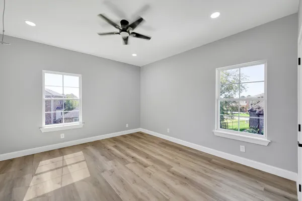 a view of a hallway view with wooden floor and staircase