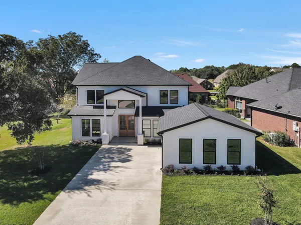 a front view of a house with a yard