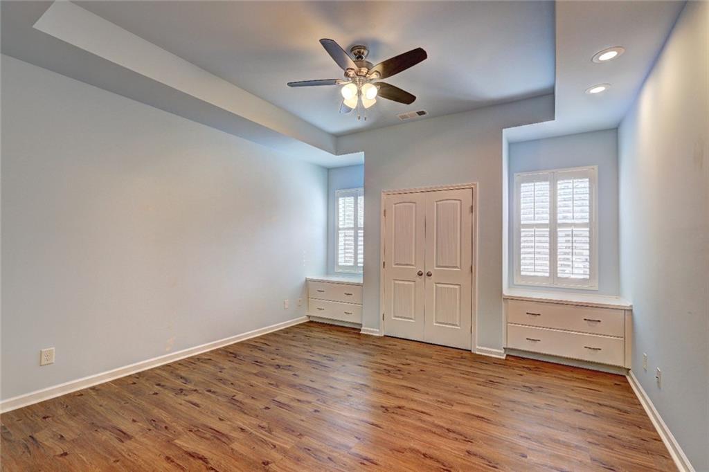 505 Riverview Lane Canton, GA 30114 - Photo 12 of 34 an empty room with wooden floor and ceiling fan
