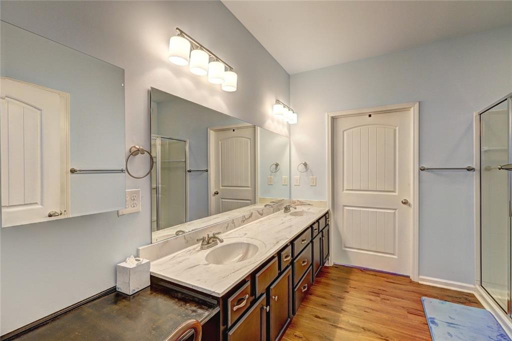 505 Riverview Lane Canton, GA 30114 - Photo 16 of 34 a bathroom with a sink a mirror and a shower