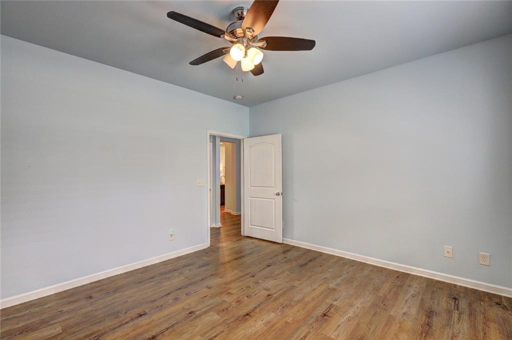 505 Riverview Lane Canton, GA 30114 - Photo 24 of 34 a view of a room with wooden floor and a ceiling fan