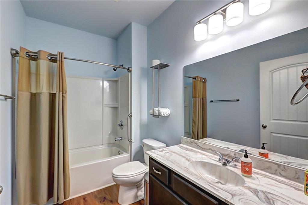 505 Riverview Lane Canton, GA 30114 - Photo 26 of 34 a bathroom with a granite countertop sink toilet and shower