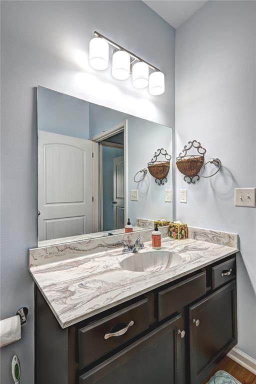 505 Riverview Lane Canton, GA 30114 - Photo 28 of 34 a bathroom with a granite countertop sink a toilet and a mirror