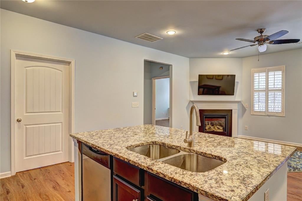 505 Riverview Lane Canton, GA 30114 - Photo 7 of 34 a kitchen with sink cabinets and a wooden floor