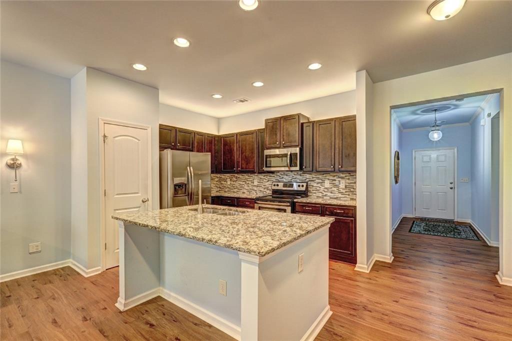 505 Riverview Lane Canton, GA 30114 - Photo 9 of 34 a kitchen with stainless steel appliances granite countertop a stove refrigerator sink and microwave