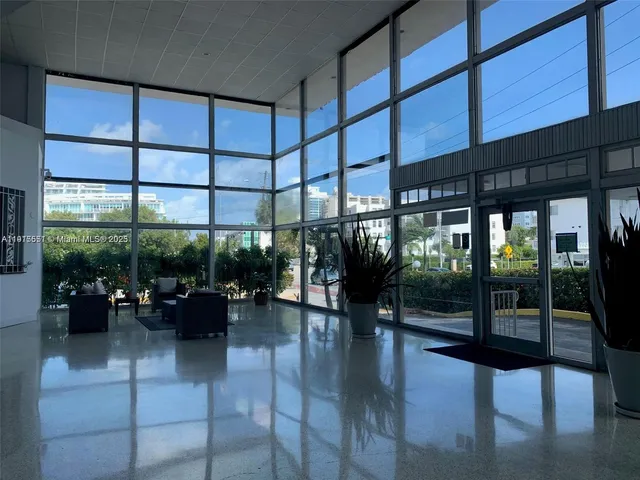 a lobby with furniture and floor to ceiling window