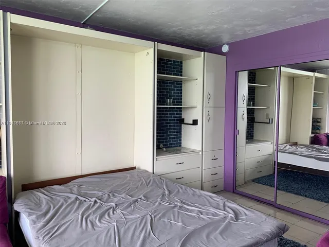 a bedroom with a bed and a closet