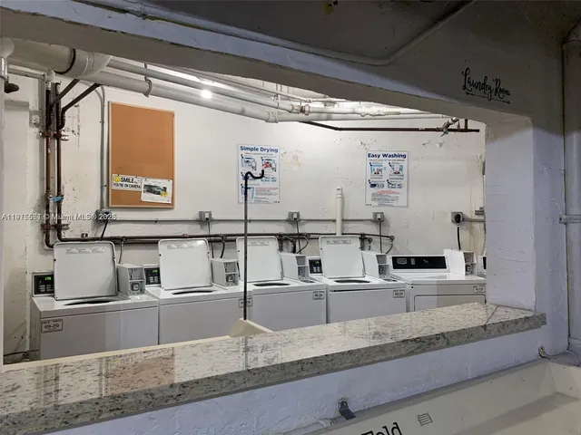 a kitchen with granite countertop a sink and a refrigerator