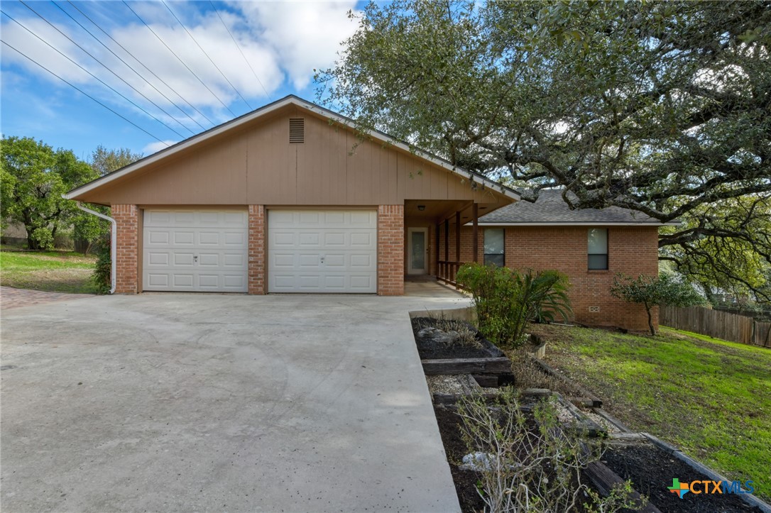 103 Mission Drive New Braunfels, TX 78130 - Photo 1 of 1 a front view of house with yard and trees