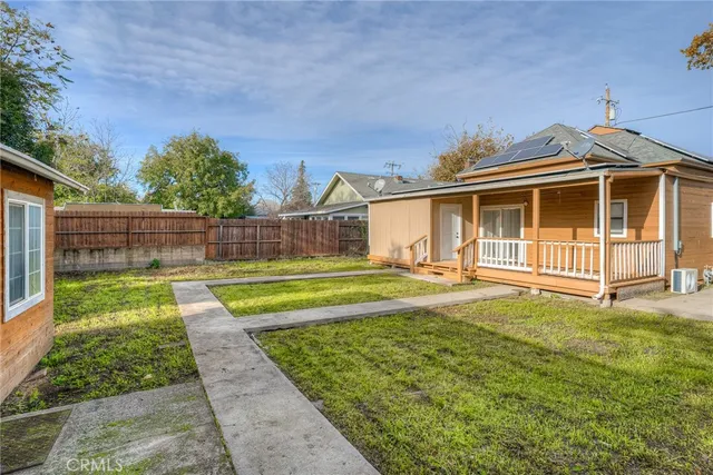 a view of a house with a backyard and a small yard