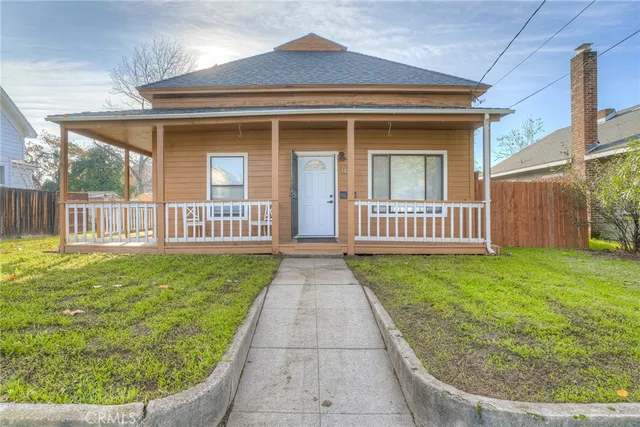 a view of a house with a small yard and wooden floor
