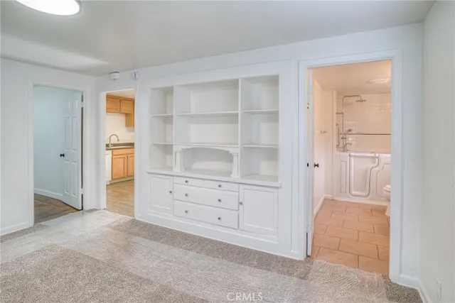 a room with closet and wooden shelves