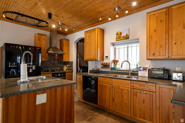 2029 West Tollgate Road Coalville, UT 84017 - Photo 24 of 36 Wood-paneled ceiling with track lighting, wood cabinetry, dark countertops, black appliances, and a stainless steel range hood