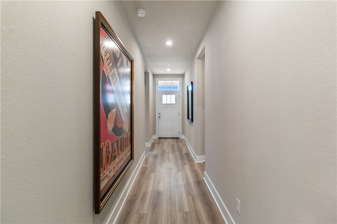 6303 Raleigh Drive College Station, TX 77845 - Photo 11 of 23 Corridor with light wood finished floors, a textured wall, and recessed lighting