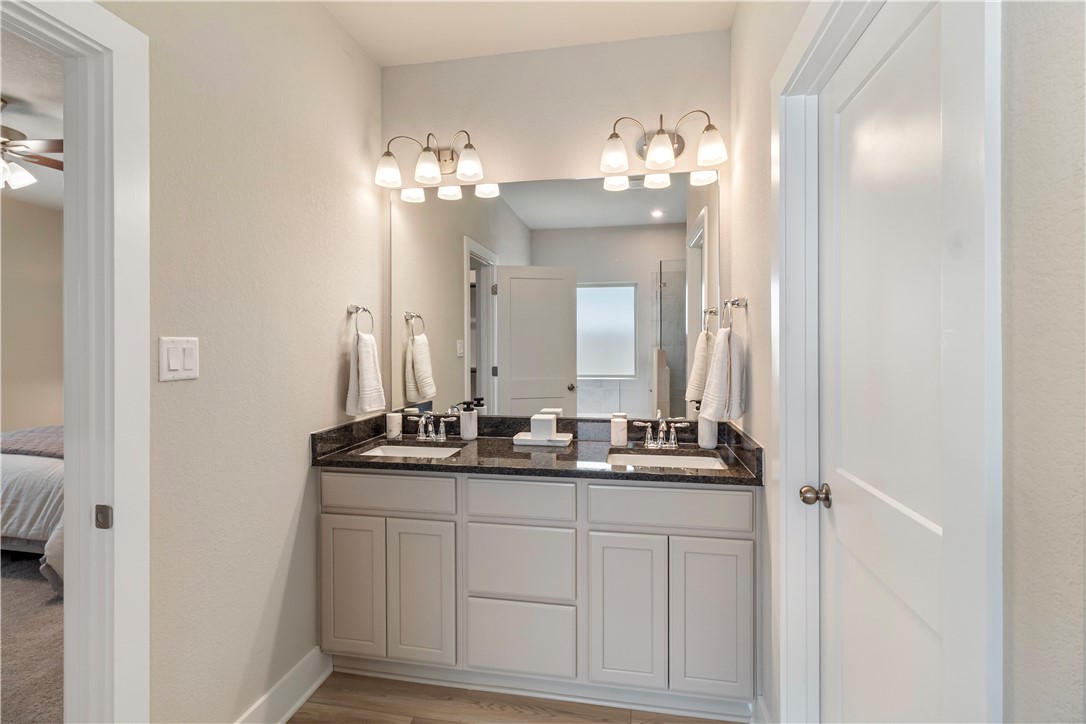 6303 Raleigh Drive College Station, TX 77845 - Photo 8 of 23 a bathroom with a double vanity and a mirror