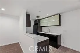 a kitchen with a sink and a refrigerator